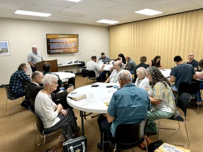 An equipping class gathered around tables at Wichita Bible Church